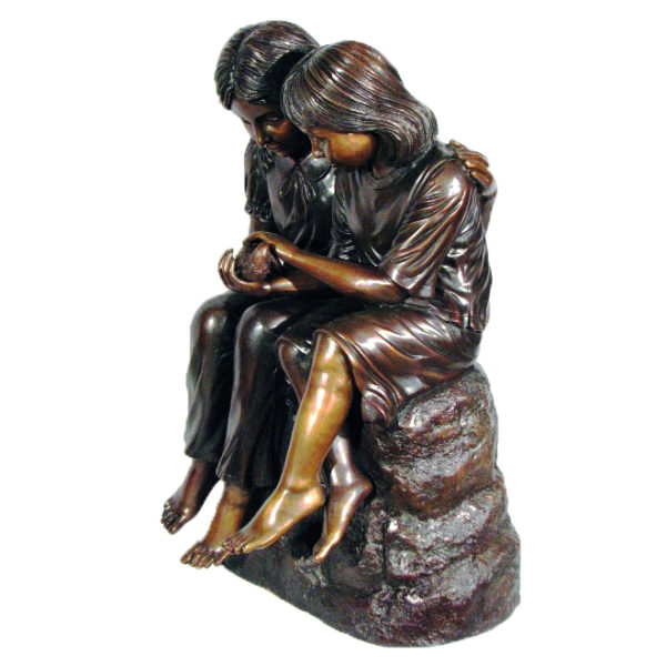 Bronze statues of boys and girls whispering