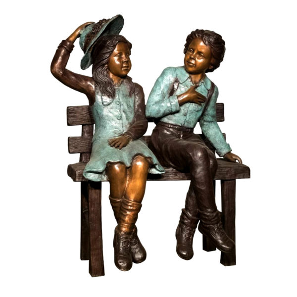Bronze statue boy and girl sat on the bench